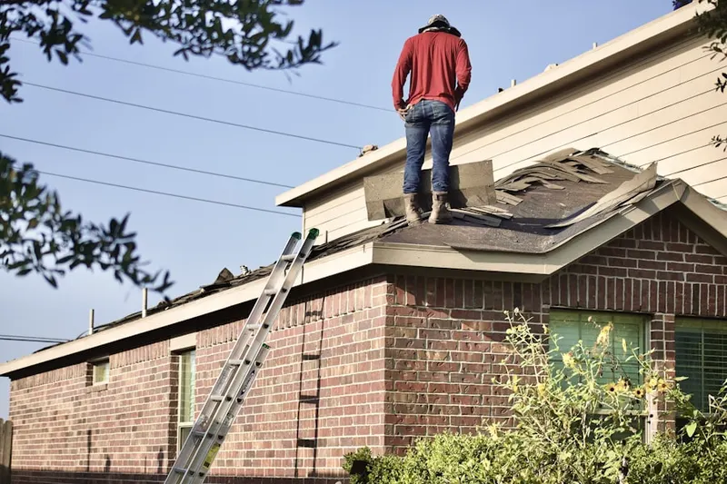 Professional roofer working on a residential roof in Gildersleeve